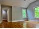 Bright bedroom with hardwood floors, two windows, and neutral wall color offers a clean and inviting space at 330 W King St, Hillsborough, NC 27278