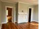 Bedroom with wood floors, fireplace, neutral paint, and white trim at 330 W King St, Hillsborough, NC 27278