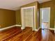 Bedroom with hardwood floors, closet and neutral paint at 330 W King St, Hillsborough, NC 27278