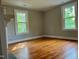 Bedroom with hardwood floors, neutral paint and bright windows at 330 W King St, Hillsborough, NC 27278