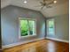 Spacious bedroom features vaulted ceiling, hardwood floors, ceiling fan, and two bright windows at 330 W King St, Hillsborough, NC 27278