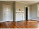 Bedroom with wood floors, fireplace, neutral paint, and white trim at 330 W King St, Hillsborough, NC 27278