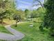 Picturesque community park featuring a winding path, picnic tables, and lush green space for recreation at 330 W King St, Hillsborough, NC 27278