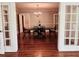 Charming dining room with hardwood floors, French doors, and a classic chandelier fixture at 330 W King St, Hillsborough, NC 27278