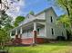 Exterior view of home with large front porch, showcasing landscaping and architectural details at 330 W King St, Hillsborough, NC 27278