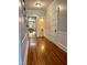 Hallway with hardwood floors leading to various rooms, offering a glimpse of the home's layout at 330 W King St, Hillsborough, NC 27278