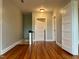 Upstairs hallway with hardwood floors, doors, and neutral wall color at 330 W King St, Hillsborough, NC 27278