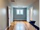 Upstairs hallway with hardwood floors, doors, and access to rooms at 330 W King St, Hillsborough, NC 27278