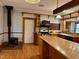 Country style kitchen with an island, granite countertops, and wooden beams at 330 W King St, Hillsborough, NC 27278
