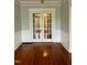 Living room featuring gleaming hardwood floors and elegant white trim at 330 W King St, Hillsborough, NC 27278