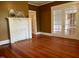 Living room showcasing hardwood floors, fireplace, and white French doors at 330 W King St, Hillsborough, NC 27278