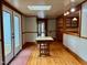 Bright living area with French doors, skylight, wooden floors, and access to the kitchen at 330 W King St, Hillsborough, NC 27278