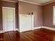 Inviting living room featuring a brick fireplace, beautiful hardwood floors, and natural light at 330 W King St, Hillsborough, NC 27278