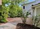 Brick patio extends from the home offering a peaceful outdoor space surrounded by lush greenery at 330 W King St, Hillsborough, NC 27278