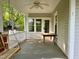 Covered front porch with a swing and table, perfect for outdoor enjoyment at 330 W King St, Hillsborough, NC 27278