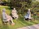 Outdoor art installation featuring three statues of women seated on benches in a landscaped park area at 330 W King St, Hillsborough, NC 27278