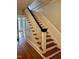 Staircase with hardwood steps, and white risers, providing access to the upper level at 330 W King St, Hillsborough, NC 27278