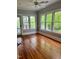 Bright sunroom featuring hardwood floors, light gray walls, and tons of natural light at 330 W King St, Hillsborough, NC 27278