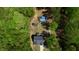 An aerial view highlighting the lot size, including the in-ground pool, shed, home and surrounding trees at 335 Gwendolyn Way, Fuquay Varina, NC 27526