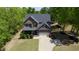 Aerial view shows beautiful two-story home with a large front yard, long driveway, and two-car garage at 335 Gwendolyn Way, Fuquay Varina, NC 27526