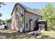The home has a patio, fire pit, and propane tank in the lawn surrounded by trees at 335 Gwendolyn Way, Fuquay Varina, NC 27526