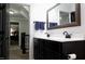 Double vanity bathroom with black cabinets, quartz countertop, and framed mirror at 335 Gwendolyn Way, Fuquay Varina, NC 27526