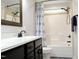 Bathroom featuring a dark wood vanity with a white countertop, a tub and shower combo, and a matching mirror at 335 Gwendolyn Way, Fuquay Varina, NC 27526