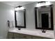 Bathroom features a double vanity with quartz countertops and decorative mirrors at 335 Gwendolyn Way, Fuquay Varina, NC 27526