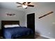 Bedroom with dark wood accents, ceiling fan, and airplane themed decor at 335 Gwendolyn Way, Fuquay Varina, NC 27526
