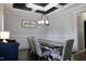 Elegant dining room enhanced with a coffered ceiling and stylish décor at 335 Gwendolyn Way, Fuquay Varina, NC 27526