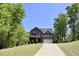 Charming two-story home with stone accents, lush landscaping, and a long driveway at 335 Gwendolyn Way, Fuquay Varina, NC 27526