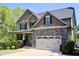 Beautiful two-story home with stone accents, an attached two-car garage, and a manicured lawn at 335 Gwendolyn Way, Fuquay Varina, NC 27526