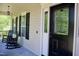 Charming front porch with rocking chairs, offering a welcoming entrance at 335 Gwendolyn Way, Fuquay Varina, NC 27526