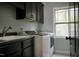 Bright laundry room features a sink, lots of counter space, a window, and a washer/dryer set at 335 Gwendolyn Way, Fuquay Varina, NC 27526