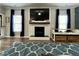 Cozy living room features a fireplace, large television and blue accent rug at 335 Gwendolyn Way, Fuquay Varina, NC 27526