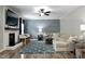 Comfortable living room featuring a fireplace, a ceiling fan, and an accent wall with modern decor at 335 Gwendolyn Way, Fuquay Varina, NC 27526
