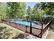 Private in-ground pool surrounded by a wooden deck with shade umbrellas for backyard fun at 335 Gwendolyn Way, Fuquay Varina, NC 27526