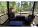 Relaxing screened-in porch with comfortable seating overlooking the beautiful wooded yard at 335 Gwendolyn Way, Fuquay Varina, NC 27526