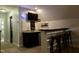 Finished basement wet bar with sink, granite countertops and barstool seating at 335 Gwendolyn Way, Fuquay Varina, NC 27526