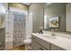 Well-lit bathroom featuring a modern vanity, shower, and toilet at 337 Sunset Hill Ln, Wendell, NC 27591