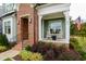 Inviting front porch with rocking chairs, brick entryway, and well-maintained landscaping, creates a welcoming curb appeal at 337 Sunset Hill Ln, Wendell, NC 27591
