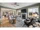 Bright living room featuring hardwood floors, large windows, a cozy fireplace, and stylish furnishings in an open layout at 337 Sunset Hill Ln, Wendell, NC 27591