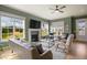 Inviting living room boasts a fireplace, large windows, and stylish furniture creating a comfortable and elegant atmosphere at 337 Sunset Hill Ln, Wendell, NC 27591