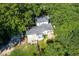 Aerial view of home featuring mature trees, backyard pond, and attached garage at 3521 Banks Rd, Raleigh, NC 27603