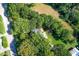 Aerial view of a home and land surrounded by trees at 3521 Banks Rd, Raleigh, NC 27603