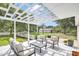 Inviting back porch with pergola cover features comfortable seating and a view of the expansive backyard at 3521 Banks Rd, Raleigh, NC 27603