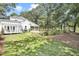 Lush backyard featuring a tranquil pond, well-maintained lawn, and the home's inviting back facade at 3521 Banks Rd, Raleigh, NC 27603