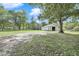A well-maintained barn sits on a large grassy lot surrounded by trees and a white fence at 3521 Banks Rd, Raleigh, NC 27603