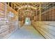 Inside the barn with wooden stalls and an open aisle, providing ample space for livestock and equipment at 3521 Banks Rd, Raleigh, NC 27603