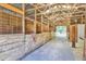 Barn interior featuring multiple horse stalls, a concrete floor, and an open, airy design at 3521 Banks Rd, Raleigh, NC 27603